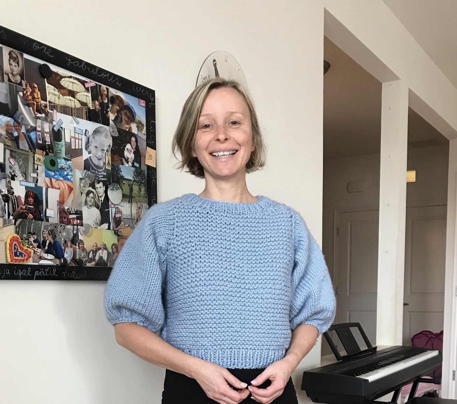 Merike Safka smiling, wearing a blue knit sweater
